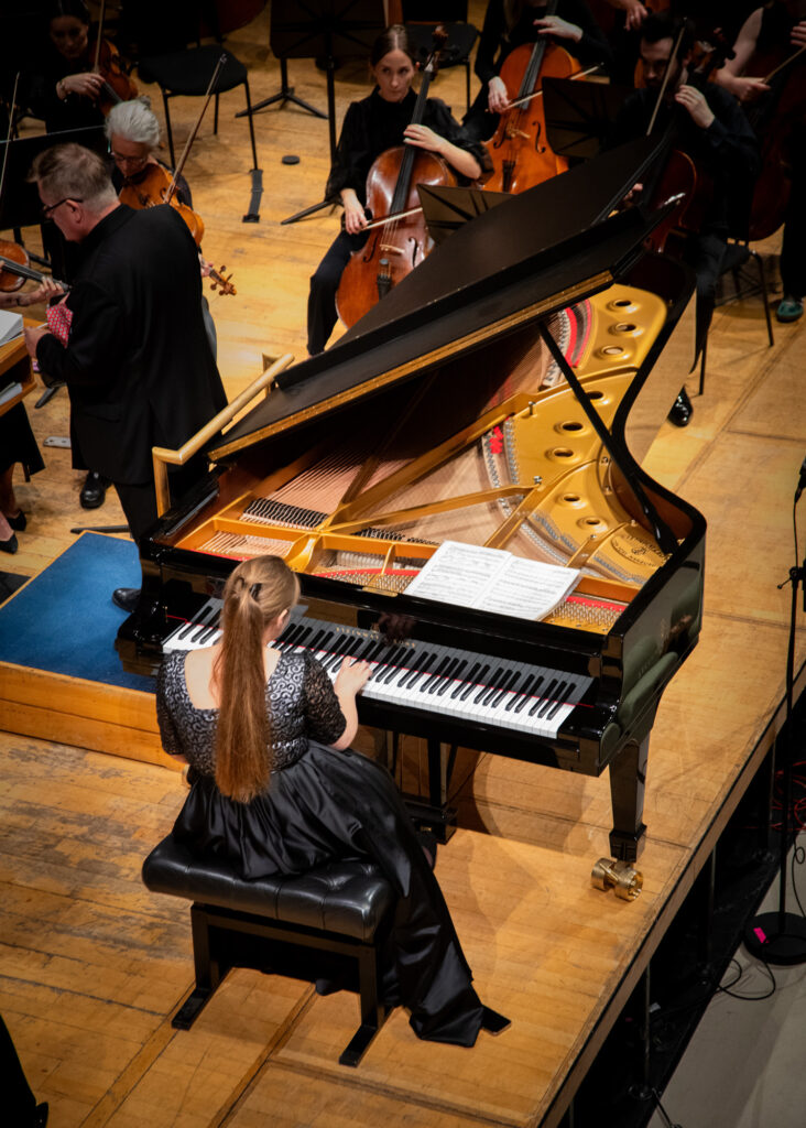 Hibernian Orchestra performance featuring piano solo with string players on stage